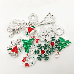 Macro shot of silver alloy Christmas tree and bell pendants for DIY jewelry making
