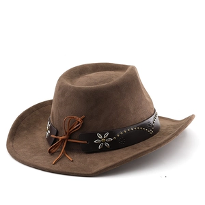 Detail of a brown suede cowboy hat featuring leather band with studs and floral charms