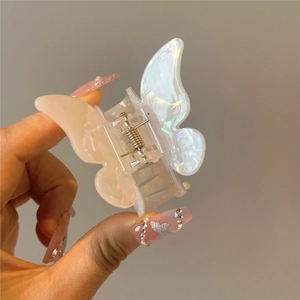 Detail of iridescent butterfly hair claw clip with translucent acrylic texture