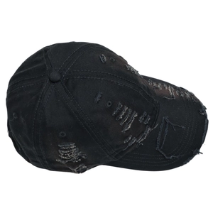 Close-up of distressed vintage black baseball cap showing ripped details and fabric texture