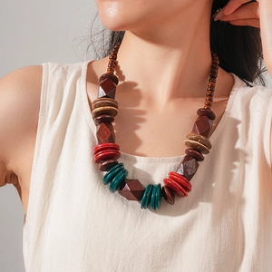 Close-up of handmade ethnic wood bead necklace with deep brown and red faceted beads