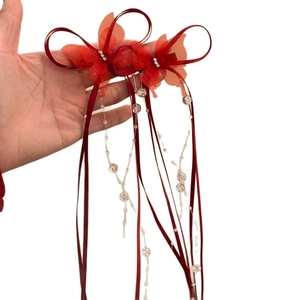 Elegant red satin bow hair clip with crystal butterfly and flowing ribbon tassels