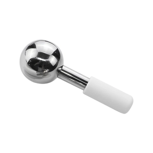 Polished stainless steel ice globe massager with a white ergonomic grip on white backdrop
