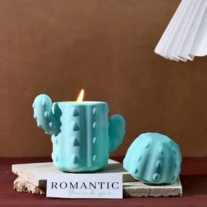 Blue cactus scented candle with lid and texture on stone base for home decor