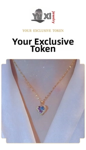 Close-up of 18k gold heart pendant featuring a gradient blue-purple stone and crystals