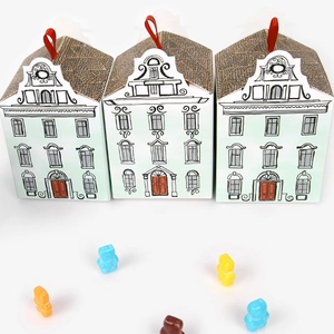 European style house shaped gift boxes with red ribbons and colorful gummy bears