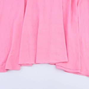 Pink bohemian maxi dress featuring asymmetric hem and textured fabric detail