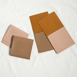 Detailed view of pink and brown PU leather drawstring pouches with neat stitching and texture