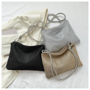 Detail of luxury rhinestone evening bags in black, silver and champagne gold colors