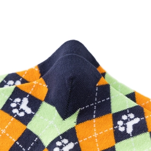 Detailed knit texture of argyle pattern socks with cute paw prints in navy and orange