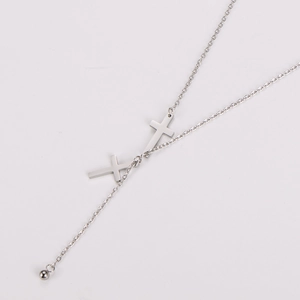 Detailed close-up of a silver stainless steel Y-necklace with cross and ball pendants