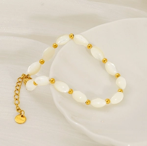Macro view of baroque pearl bracelet with gold stainless steel extender and brand tag