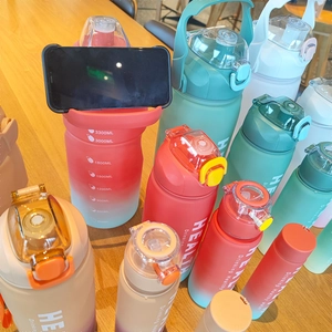 Set of four gradient color plastic water bottles with straws and capacity markings