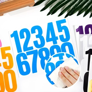 Close-up showing waterproof durability of vinyl number stickers with water droplets
