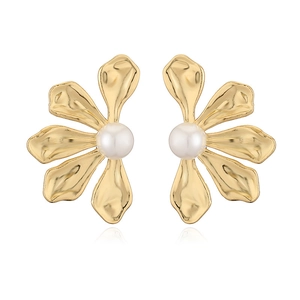 Detail of vintage French gold flower earrings with elegant white pearls on white background