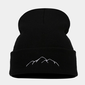 Detailed view of the mountain embroidery on the black ribbed knit beanie's cuff