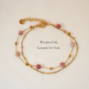 Detail view of gold double-layer bracelet with pink beads and S.steel hallmark engraved