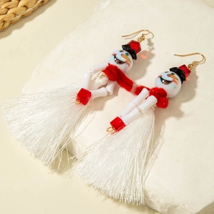 Detail of beaded snowman earrings with red scarves and long white decorative tassels