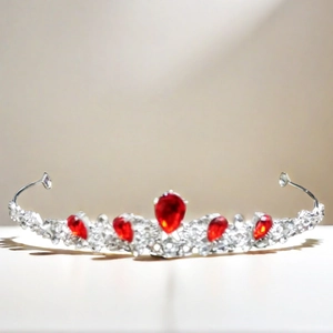 Close-up of luxury bridal tiara with red teardrop gems and sparkling cubic zirconia stones