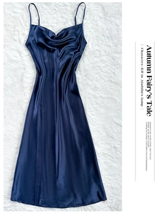 Detail of navy blue satin slip dress with elegant cowl neck and thin shoulder straps