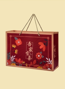 Close-up of red wedding gift bag with gold handles and Chinese floral pattern