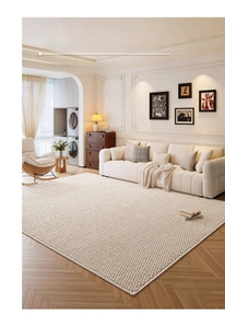 Detail view of pearl white sisal-like rug with textured tufted pattern on wood floor