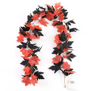 Detail of autumn maple leaf garland with dual-tone leaves and battery power box