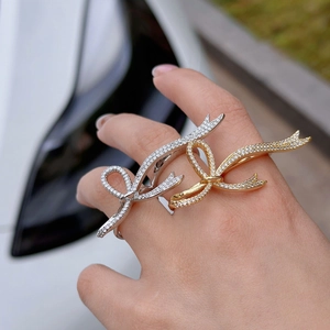 Adjustable bow ring in gold and silver finish with sparkling pavé crystals for women
