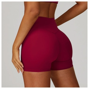 Detail of high-waisted yoga shorts in dark red with V-waist contour and peach lift