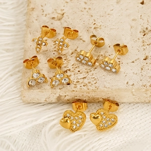 Golden heart and cross stud earring set with zircons on elegant textured stone
