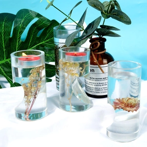 Detail of DIY heart cylindrical resin mold featuring real dried flowers and candle