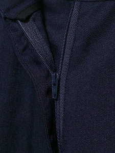 Macro shot of navy blue twill fabric zipper and professional stitching details on trousers