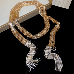 Detailed close-up of golden mesh chain with sparkling rhinestone fringe tassels