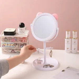 Desktop cat-ear vanity mirror with jewelry hooks and storage tray in pink and white