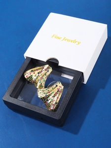 Detailed close-up of 18K gold plated fan earrings with colorful rhinestones in a gift box