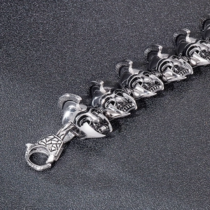 Macro view of retro silver Spartan helmet links on a punk style titanium steel bracelet