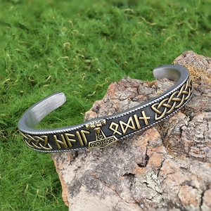 Viking Mjolnir open cuff bracelet with Nordic runes on natural moss background
