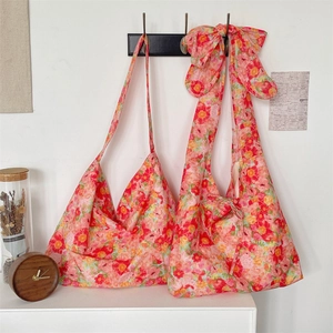 Close-up of floral cotton tote bag featuring a large decorative bow on the strap