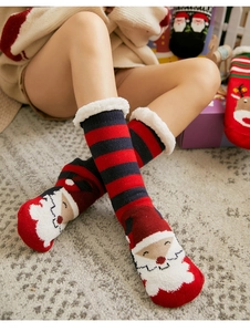 Close-up of Santa Claus pattern on red plush thermal floor socks with white faux fur trim