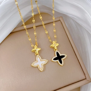 Luxurious gold plated clover pendant necklaces with black onyx and white shell inserts