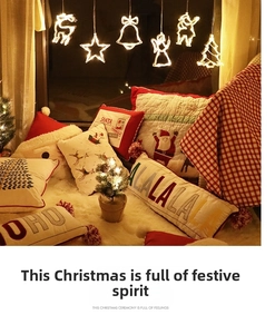 Christmas pillow cases set on soft white rug with warm holiday hanging lights background