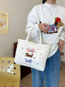 White quilted cotton tote bag featuring cute cat embroidery and lucky lettering charm