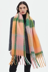 Detailed view of oversized plaid scarf with long tassels and soft boucle texture