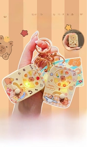 Capybara rotating keychain detail with light-up function and cartoon graphic design