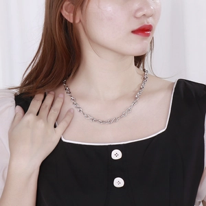 Detailed view of silver infinity link chain necklace on model with polished finish