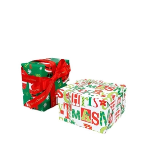 Christmas wrapping paper with Santa and Merry Christmas text on boxes with red ribbons