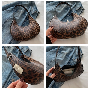 Detail view of leopard print shoulder bag featuring silver metal lock and textured PU leather