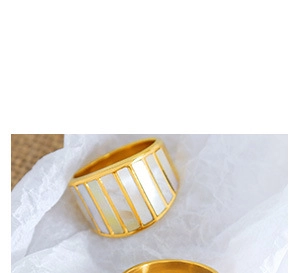 Detail of wide gold plated ring featuring white rectangular mother-of-pearl inlay