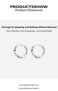 Close-up of S999 silver Mobius twist hoop earrings with polished metallic texture