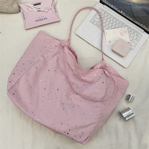 Pink star-patterned tote bag shown with a laptop and cosmetics for daily lifestyle use